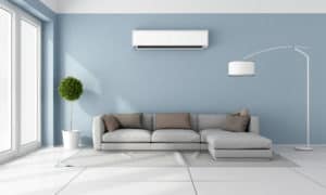 Blue living room with gray sofa and air conditioner on wall